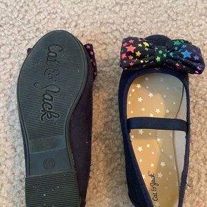 Black dress shoes with rainbow star bow.